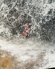 A person is refreshing in Lasir Waterfall in Lake Kenyir, Terengganu Malaysia.