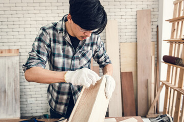 Carpenter Man is Working Timber Woodworking in Carpentry Workshops, Craftsman is Applying Glue to Timber Plank for Wooden Furniture in Workshop. DIY Workmanship, Job Carpenters Concept