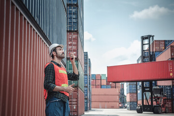Container Logistics Shipping Management of Transportation Industry, Transport Engineer Managing Control Via Walkie Talkie in Containers Shipyard. Business Cargo Ship Import/Export Factory Logistic.