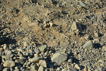 Fototapeta na wymiar Brown soil dirt with stones and pebbles
