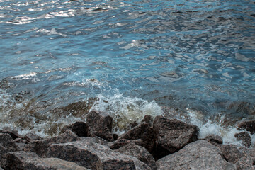 natural background waves and beach made of stones