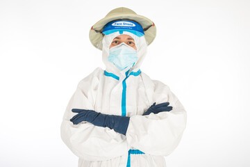 Fototapeta premium Female doctor wearing PPE to fight the coronavirus, wearing a colonial-era explorer's hat, on a white background. Warrior. COVID medicine concept