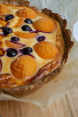 berry cake with yellow apricots and blueberries