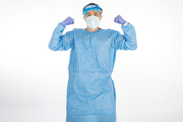 Doctor wearing blue PPE to fight coronavirus, showing how strong he is, on white background. Warrior. COVID medicine concept