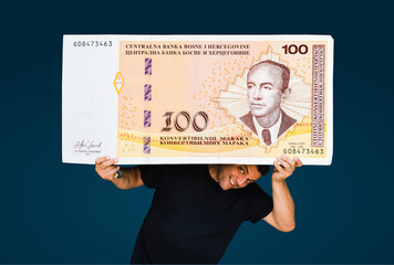 man holding a huge 100 BAM bosnian money - obrazy, fototapety, plakaty