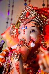 Low angle Close up shot of Hindu God Ganesha Chaturthi idol in a sitting position, Lord Ganesh.