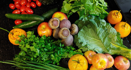 A small variety of fruits and vegetables that have just arrived from the organic fair.