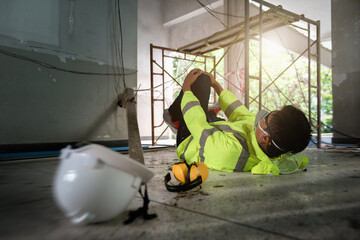 Knee accident at work of construction worker at site. Builder accident falls scaffolding on floor,...