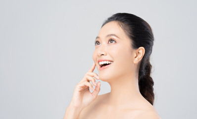 Naklejka premium Beautiful female asian face with natural perfect skin in studio portrait