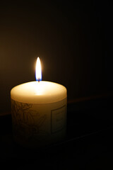 Lonely candle in the dark