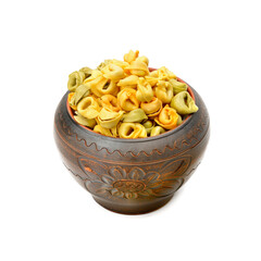 Ravioli in a clay pot isolated on a white background.