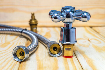 Cruciform hot and cold water main switch of spare parts on wooden boards