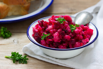 Traditional Russian lean vegetable salad vinaigrette in an iron bowl.