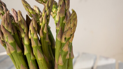 Isolated macro photo of the top of several a green asparagus. This concept photo relates to healthy eating and a vegetarian lifestyle.