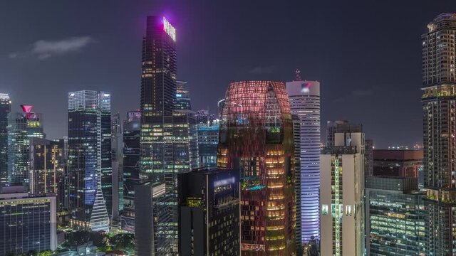 Aerial cityscape of Singapore downtown of modern architecture with illuminated skyscrapers night timelapse, view from above from skybridge viewpoint with glowing windows in towers