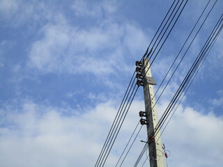 Fototapeta premium High voltage power lines against blue sky