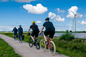 Group of cyclists on the background of a beautiful rural landscape