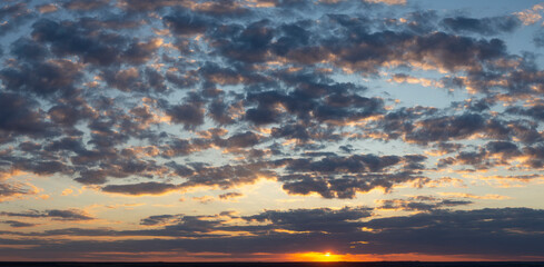 The evening sunset. Panorama. Purple clouds. Tragic gloomy sky.