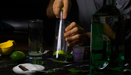 man holding a glass of a mojitos 