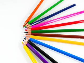 Color pencils on white in arch form close up shot , space for text.