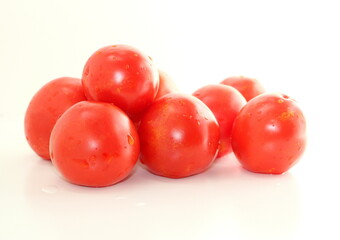 Red natural tomatoes isolated on white background.