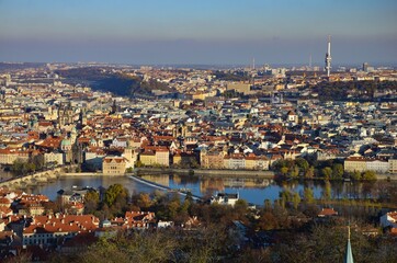 Prague city with Charles Bridge, aerial view towards river Moldau, sunny day in autumn