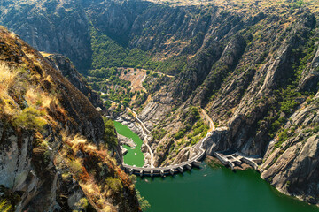 Obraz na płótnie Canvas Top view of the hydroelectric dam from the viewpoint of El Fraile, natural landscape with the valley and the Duero river. Flight of birds of prey, Salamanca, Spain