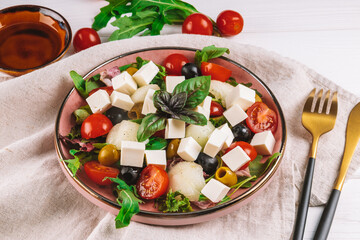  Italian salad with feta, olives, tomatoes, arugula and melon.