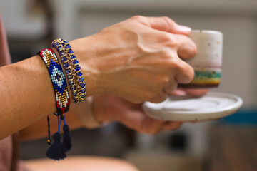 close up of a hand holding a bracelet