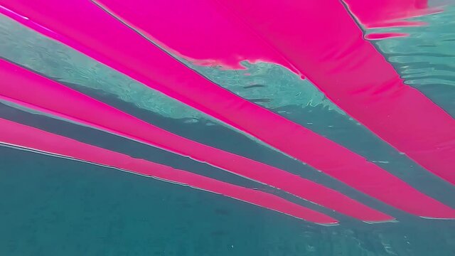 A pink rubber mattress runs through the frame, underwater shoot
