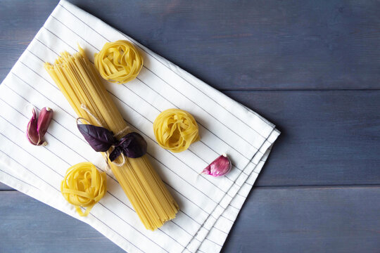 raw pasta lie on a gray wooden table