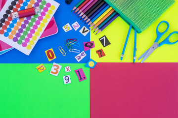 Items for back to school on colorful background,  pencils, notebooks, scissors elements and text - education concept