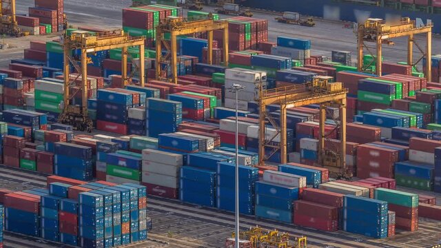 Commercial port of Singapore aerial timelapse. Bird eye close up view to loaders of busiest Asian cargo port with hundreds of ships loading export and import goods and thousands of containers in