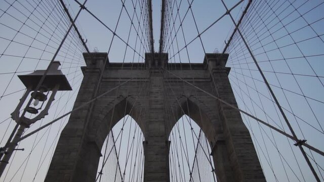 SLOW MOTION: Empty Brooklyn Bridge with no people early morning at sunrise in beautiful sunlight in summer 