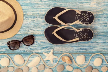 Gordijnen Beach accessories on wooden board. Vacation and travel items, top view © Sergey Makarenkov