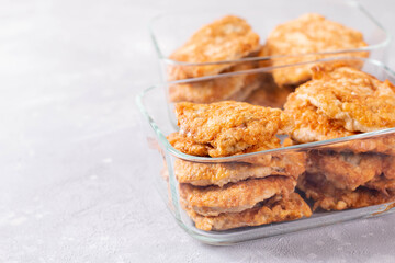 Meal prepping. Fried meat in a glass container. Copy space.