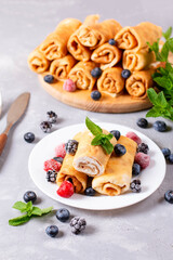 Thin pancakes with cottage cheese. Delicious sweet rolled pancakes