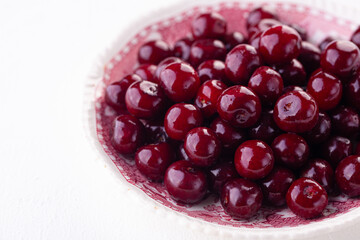 ripe cherry in close-up on white background. Copyspace