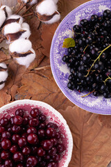 ripe berries: black currant and cherry in close-up on vintage plates