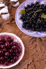 ripe berries: black currant and cherry in close-up on vintage plates