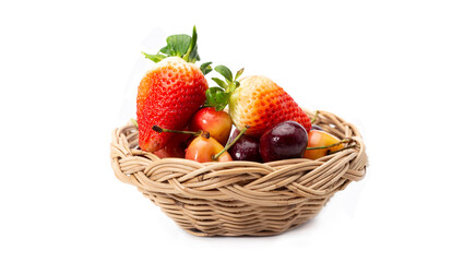 Strawberries, and Cherries in woven basket isolated on white background.