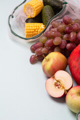 autumn vegetables and fruits in eco bags and place for text.