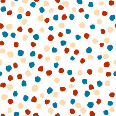 Colorful polka dot. Red, blue and caramel sprinkles on white background. Seamless pattern