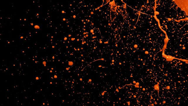 Orange paint splash thrown in slow motion, liquid isolated on black (4K)