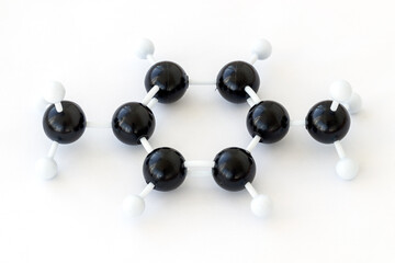Plastic ball-and-stick model of a 1,4 dimethylbenzene or para-xylene molecule (CH3)2C6H4, one of the xylene isomeres, shown with kekule structure on a white background.