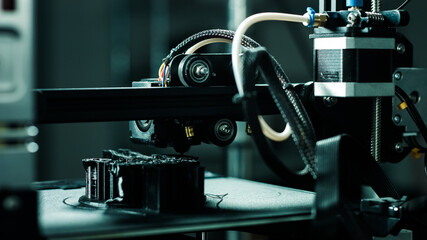 3D printer working in a factory printing plastic part.