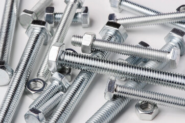 Lots of metal bolts and nuts. Tool for fixing. White background