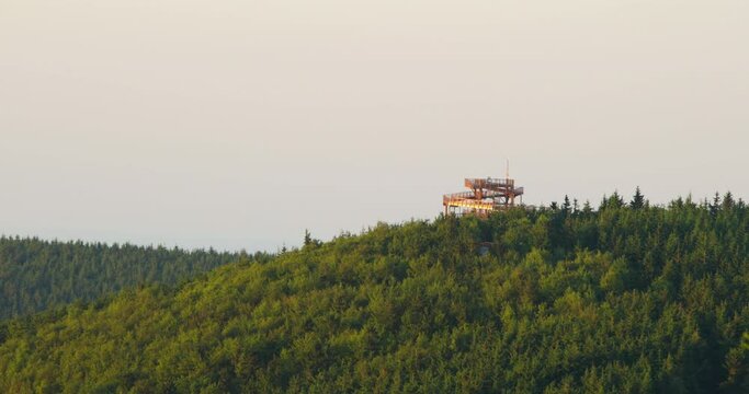 Wooden skywalk view point in the treetops on the top of Pustevny lying in the middle of the forest during a sunny day zoome inside.