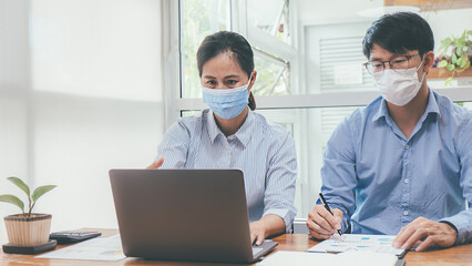 Fototapeta na wymiar Asian People Successful Teamwork Business Wearing Medical Mask and Working. Work from Private Office Social Distancing among Coronavirus Outbreak Situation