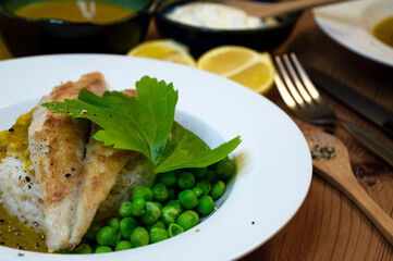 grilled fish fillet on rice on wooden table